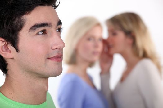women sharing secrets about young man