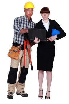 Architect and builder looking at a laptop