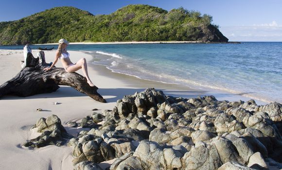 A young girl on a tropical beach in the islands of Fiji in the South Pacific (Model Released).