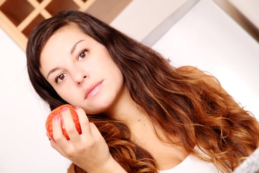 A young adult woman eating a Apple.