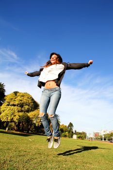 A young woman jumping in the Park.