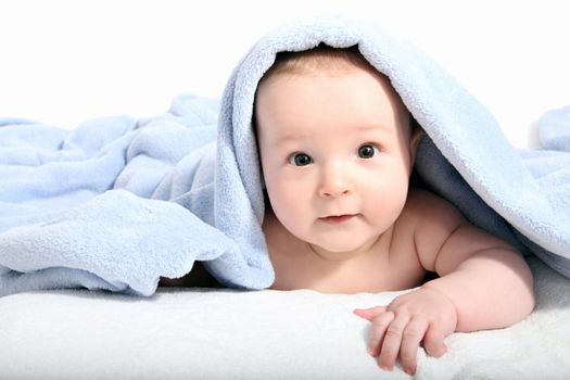 beautiful baby after bath under a blanket