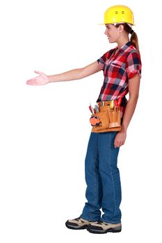 A female construction worker about to shake hands.