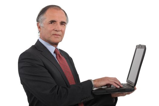 A mature businessman with a laptop.