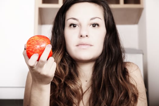 A young adult woman eating a Apple.