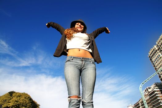 A young woman enjoying the sunlight in the Park.			