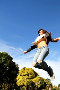 A young woman jumping in the Park.