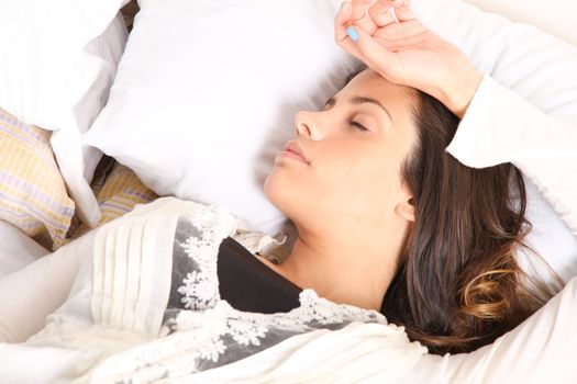 A woman lying alone on the bed.
