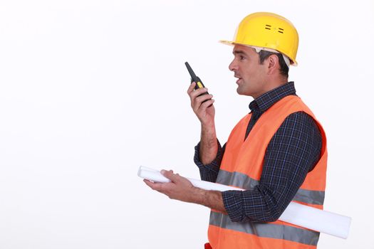 construction site supervisor talking on his walkie talkie