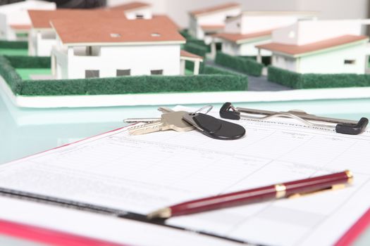 Clipboard next to a model housing estate