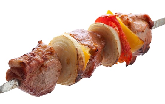 Hot roasted meat with onion, tomato and pepper on the metal skewer