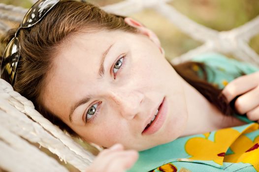 Portrait of a young girl lying in a hammock