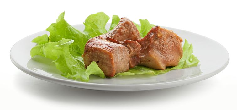 Three pieces of roasted meat with fresh lettuce on the white plate