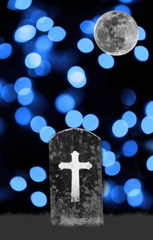 full moon and headstone in graveyard with blue abstract lights