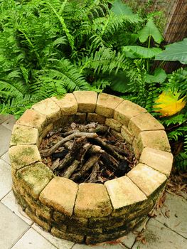 fire pit with lush foliage in background