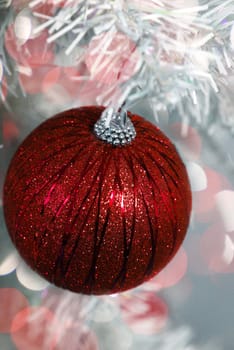red glitter christmas ornament with red glowing lights