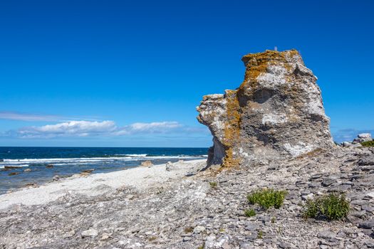 Cliff on the Baltic Sea coastline. Fåröisland in Gotland, Sweden. This rock formation is called "rauk" in Swedish.