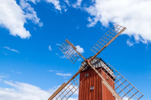 Old wooden windmill under blue sky. Gotland, Sweden.