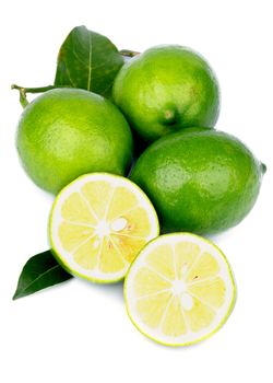 Heap of Fresh Ripe Green Lemons with Halves and Leafs isolated on white background