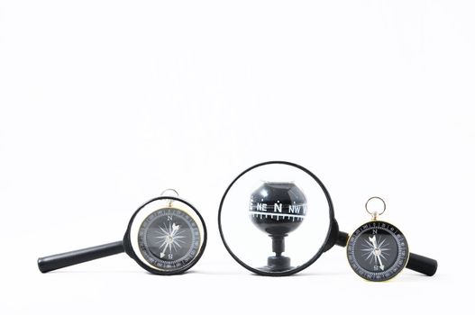 Orientation Concept Magnify Glass and Compass on a White Background