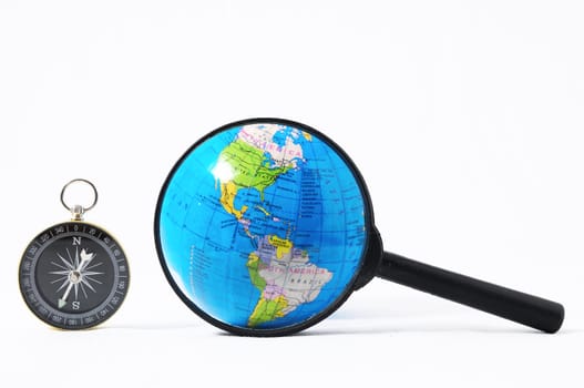 Orientation Concept Earth,Magnify Glass and Compass on a White Background