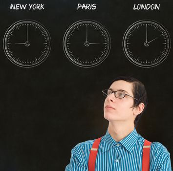 Nerd geek businessman with chalk time difference clocks on blackboard background