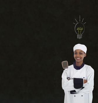 Bright idea lightbulb thinking African or African American woman chef on chalk blackboard background