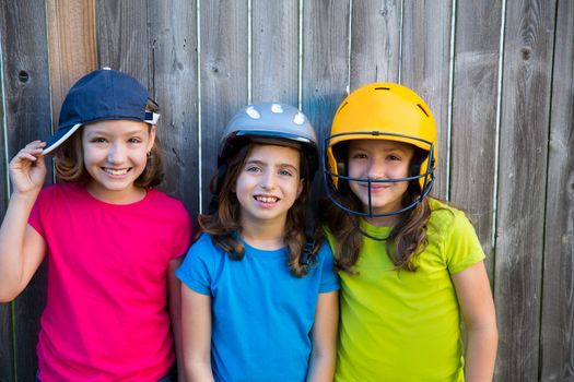 Sister and friends sport kid girls portrait smiling happy on gray fence wood backyard