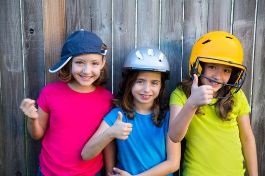 Sister and friends sport kid girls portrait smiling happy on gray fence wood backyard