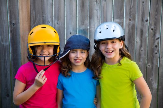 Sister and friends sport kid girls portrait smiling happy on gray fence wood backyard