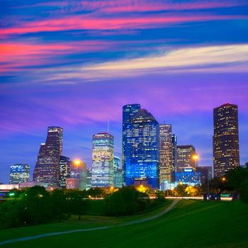 Houston Texas modern skyline at sunset twilight from park lawn