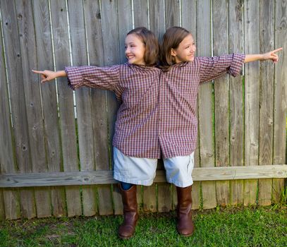 twin girls fancy dressed up pretending be siamese with his father shirt pointing finger