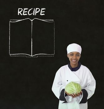 Chef with recipe book on chalk blackboard menu writing background