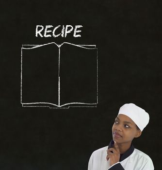 Chef with recipe book on chalk blackboard menu writing background