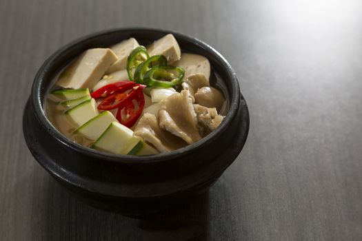 A heated stone bowl dish of korean vegetarian food.