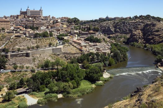 The city of Toledo in the La Mancha region of central Spain. View of the city and the Alcazar from the viewpoint over the River Targus. 