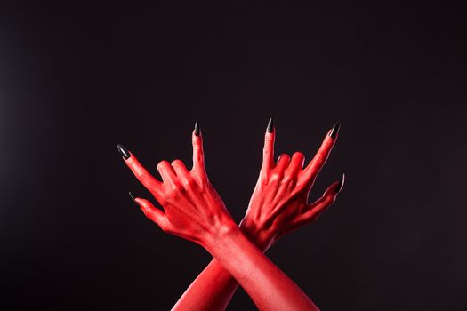 Red devil hands showing heavy metal gesture, Halloween theme 