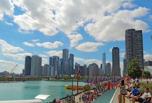 CHICAGO, ILLINOIS - SEPTEMBER 4: Tourists and a view of the cityscape at Navy Pier in Chicago, Illinois on September 4, 2011. The Pier is a popular destination with many attractions on Lake Michigan.