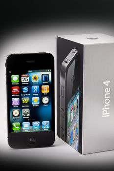 An Apple iPhone4 with it's delivery box.