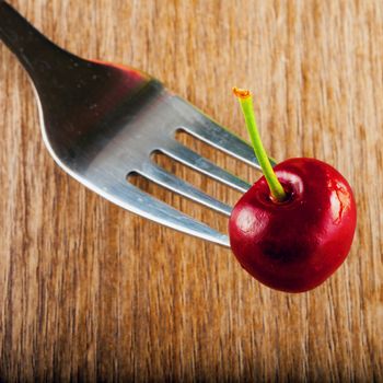 Wonderful red cherry skewered over a fork