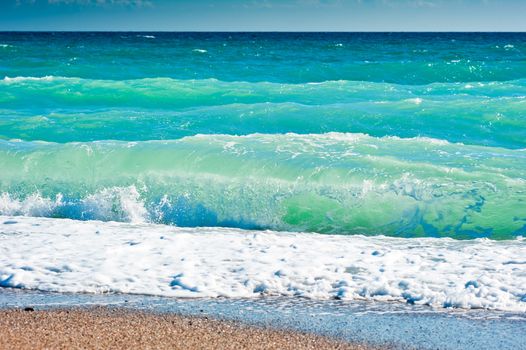 Splash of sea foam on a sandy beach