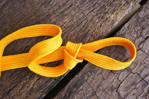 The yellow rope made of synthetic fabrics