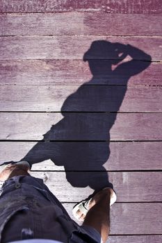 Human with the sunlight shadow on the wooden platform