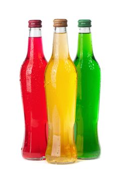 Assortment of cold bottles of pop or coolers on white background