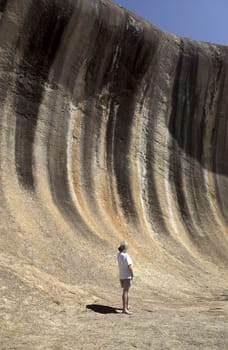 Wave Rock is a natural rock formation located east of the small town of Hyden in Western Australia. The wave part of the rock is about 14 m (47 ft) high and around 110 m (350 ft) long. It is composed of granite and its rounded wave-like shape was formed by subsurface chemical weathering followed by removal of the soft weathered granite by fluvial erosion.