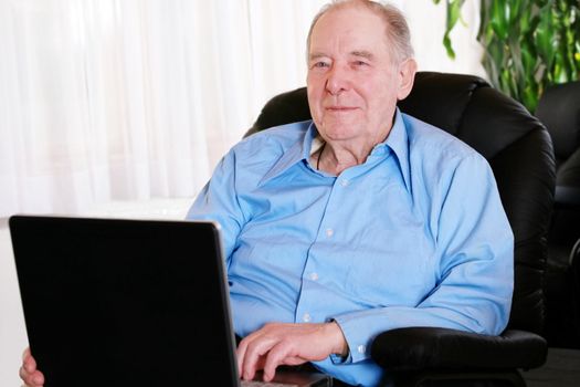 Elderly man using laptop computer