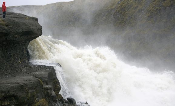 Water cascades into the canyon making walls of spray at Gullafoss Waterfall in Iceland (Model Released)