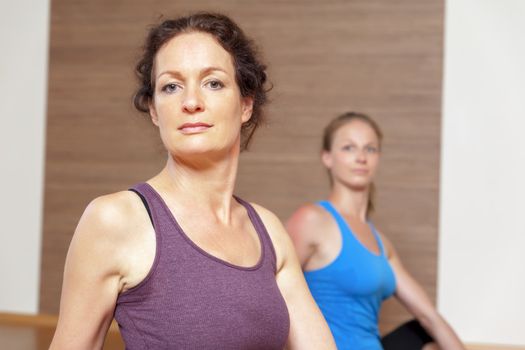 An image of some people doing yoga exercises