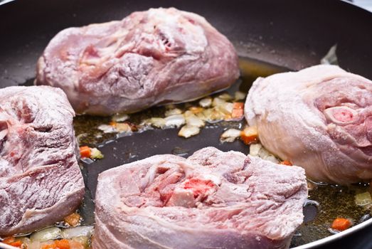 Paesant food. floured osso buco in pan