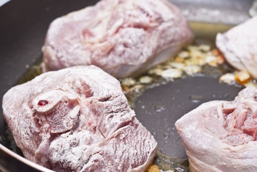 Paesant food. floured osso buco in pan